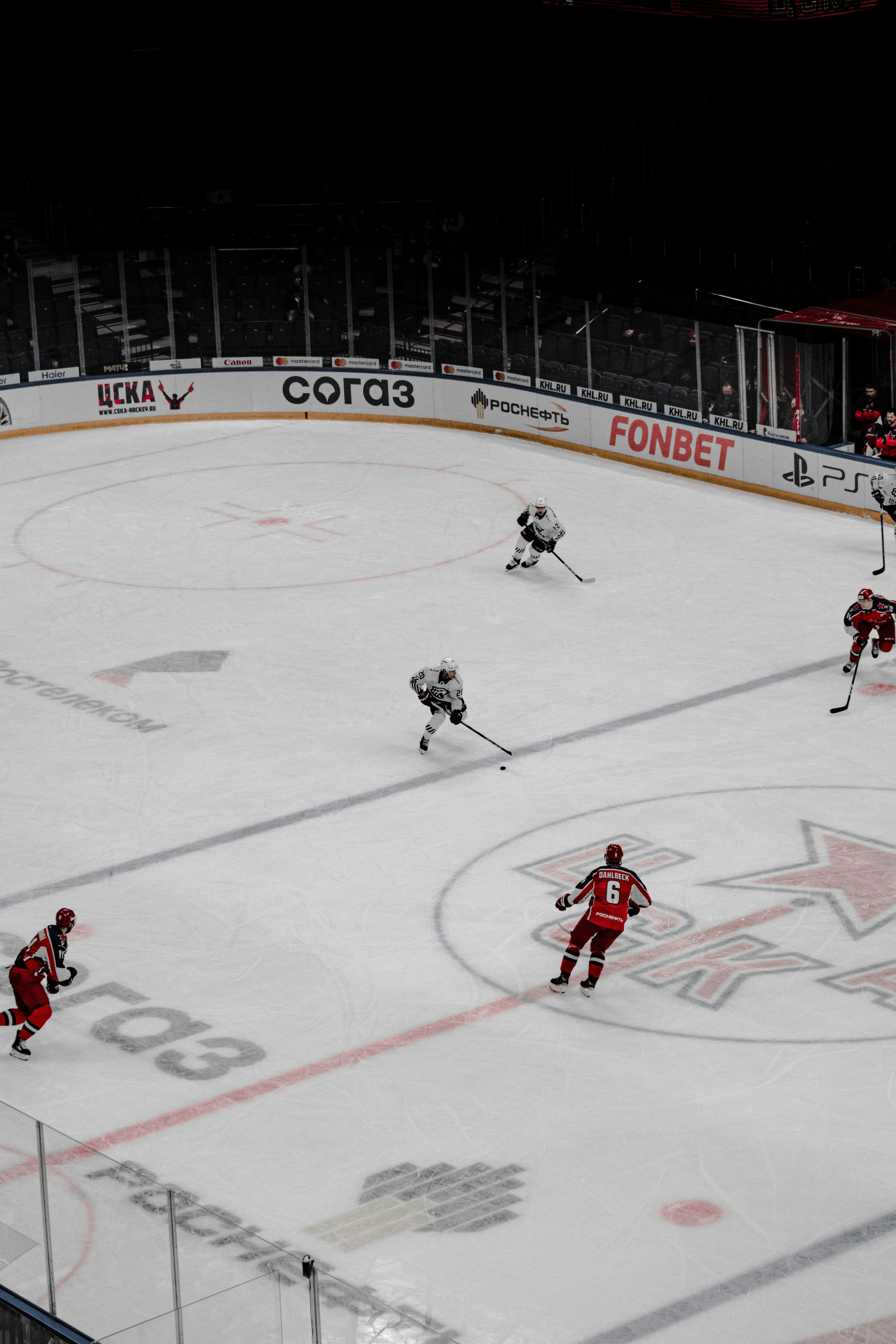 people playing ice hockey on ice field